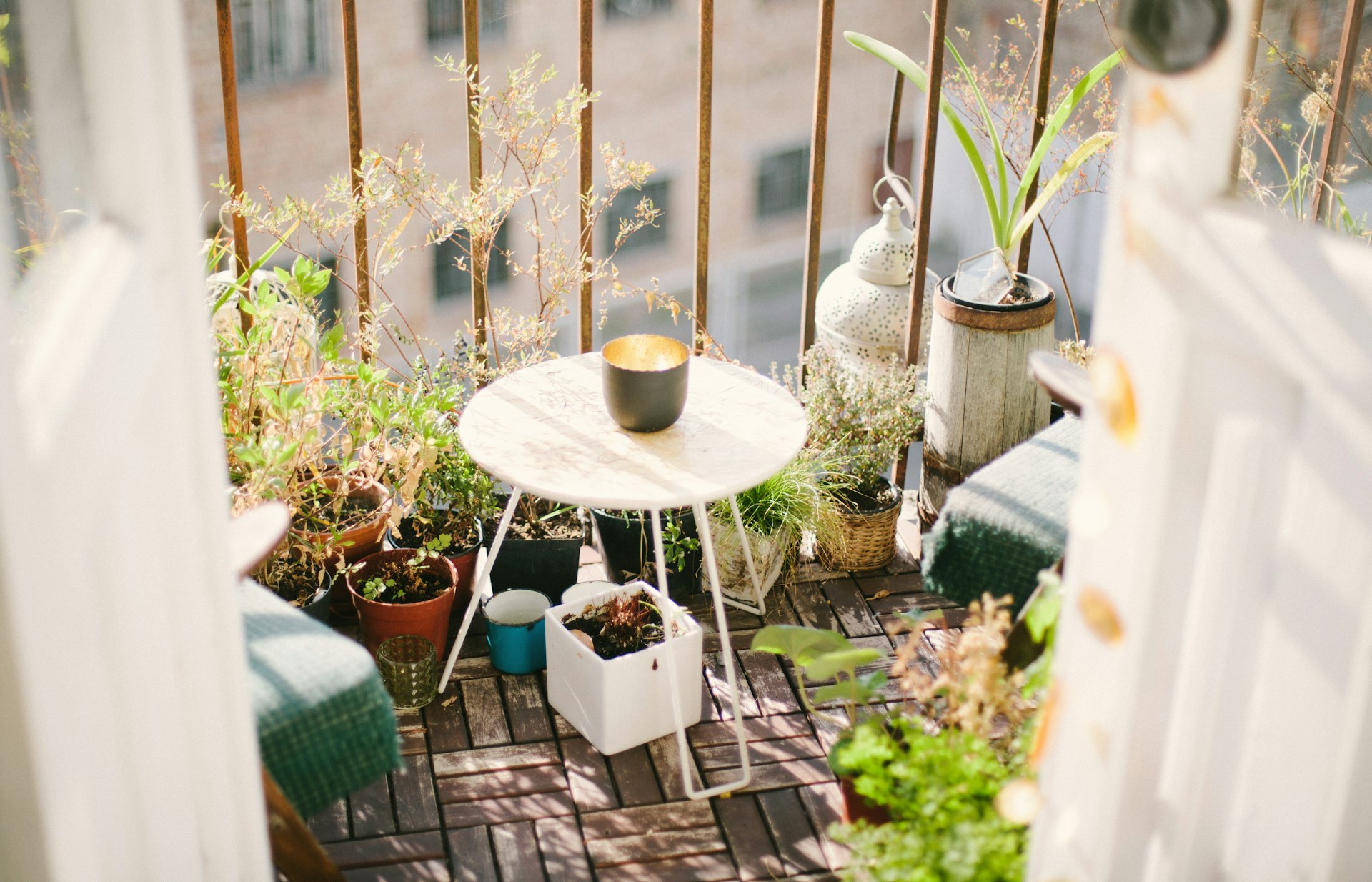 Small terrace garden with a round table surrounded by potted plants